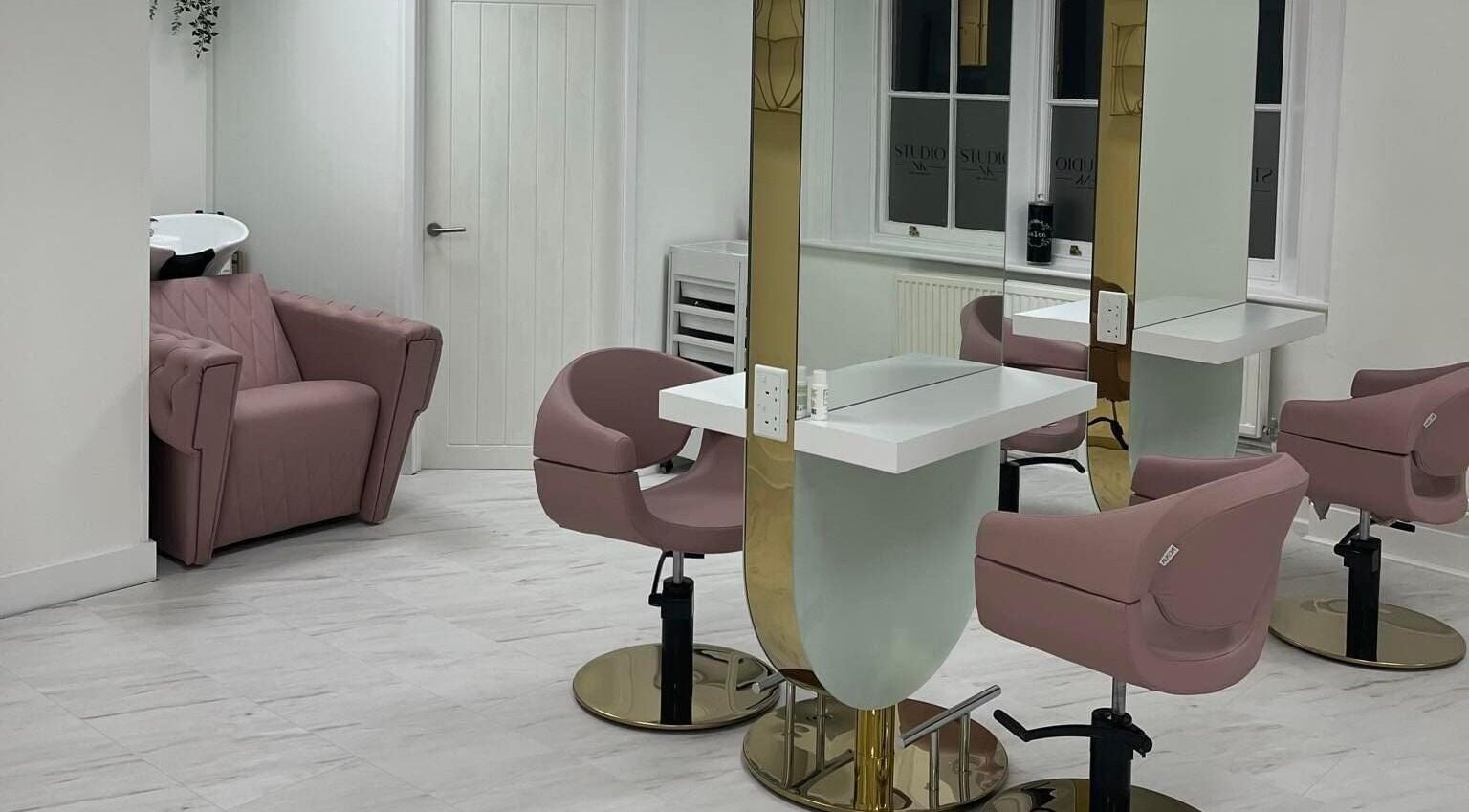 Elegant studio space with pink chairs and mirrors at Studio NK, Newbury, England, GB.