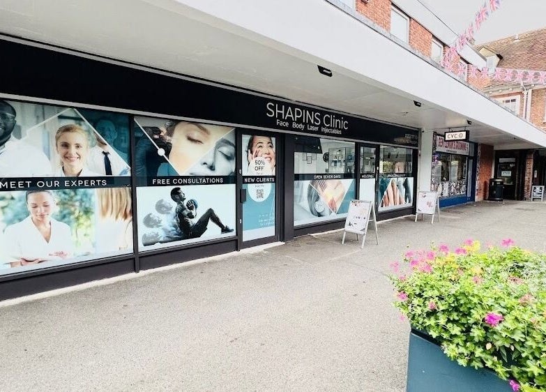 Front view of SHAPINS Clinic Farnham, showcasing modern design at Farnham, England, GB with vibrant floral decor.