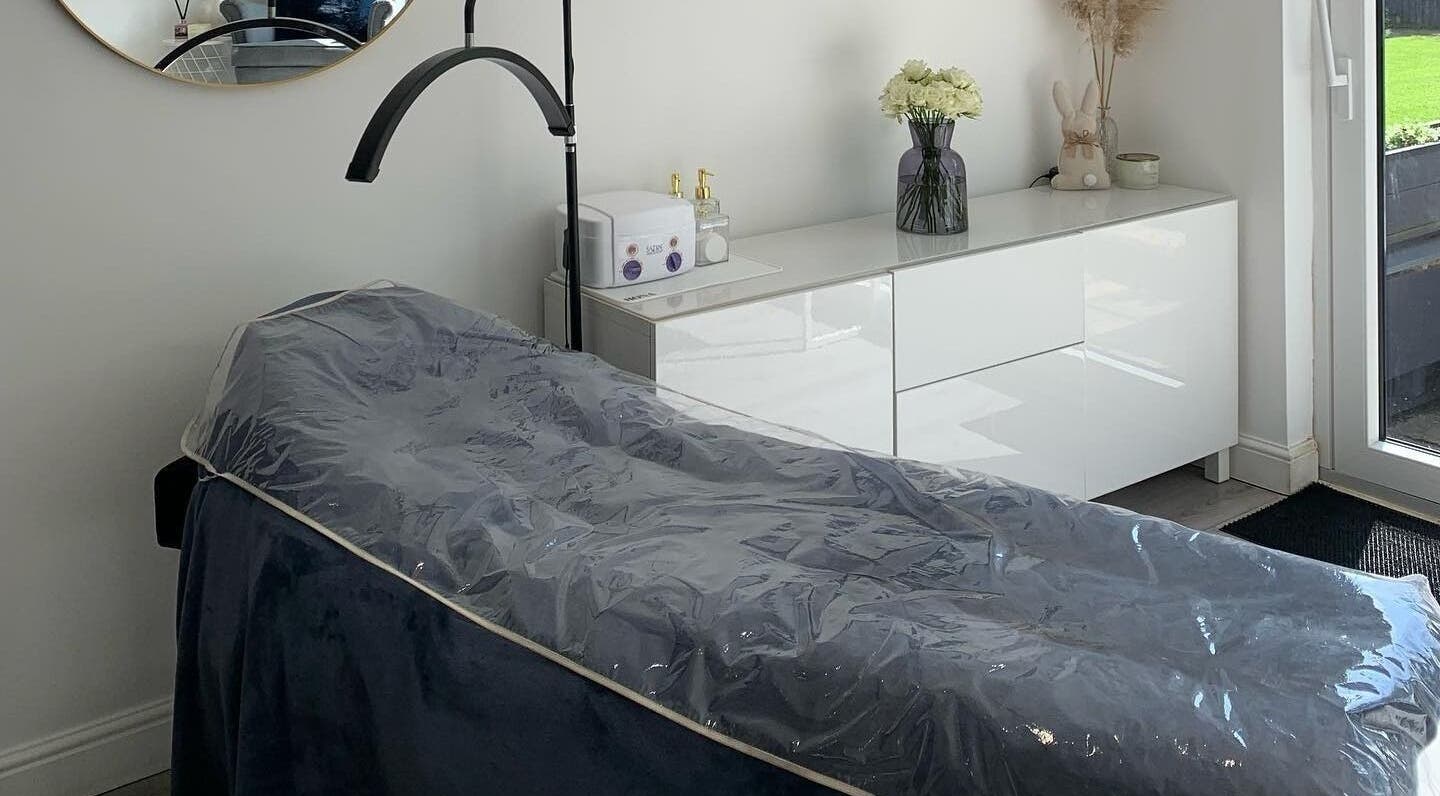 Elegant spa room at Evoke Beauty, Clophill, England, GB, featuring a cozy treatment bed.