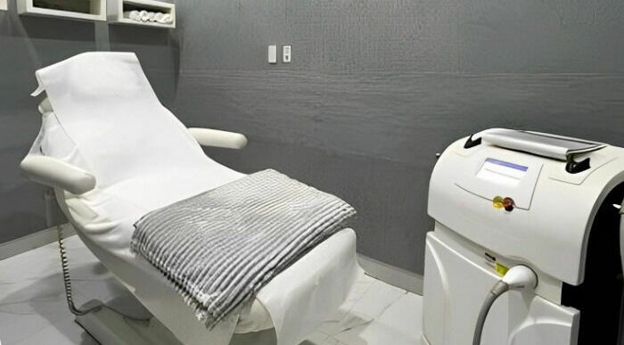 Spa treatment room at Adore Medispa, Cancún, Quintana Roo, MX, featuring a plush treatment bed and equipment.