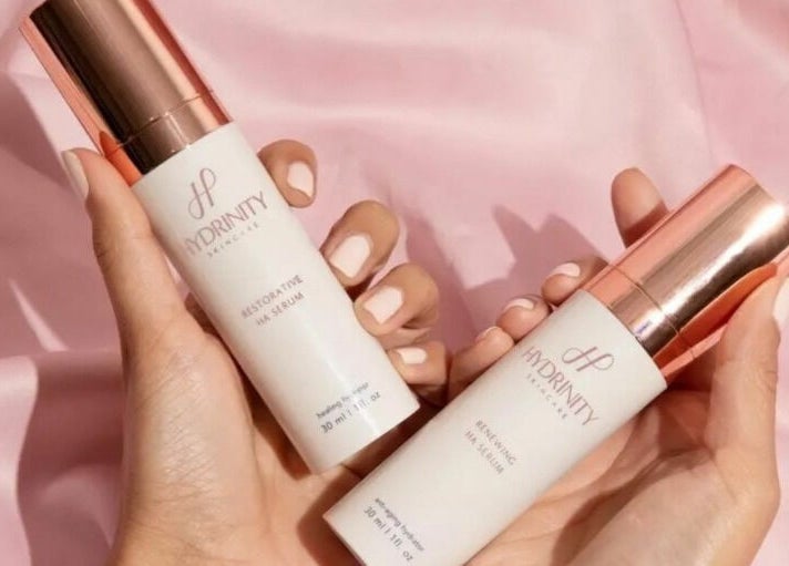 Hydrinity skincare serums at Adore Medispa, Cancún, Quintana Roo, MX on a pink satin background.