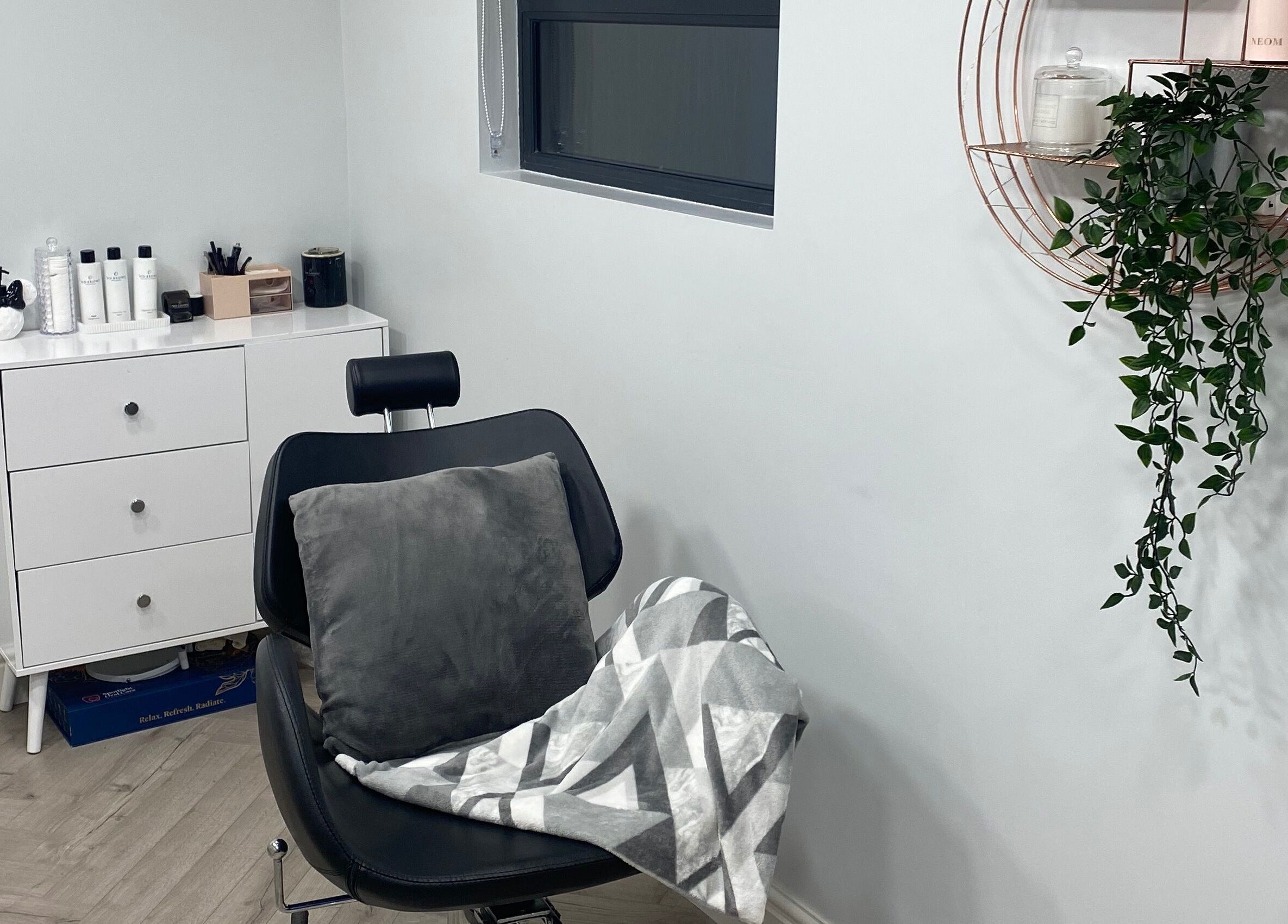 Cozy salon corner in Studio S, Lucan, County Dublin, IE, with a plush chair and soothing decor.