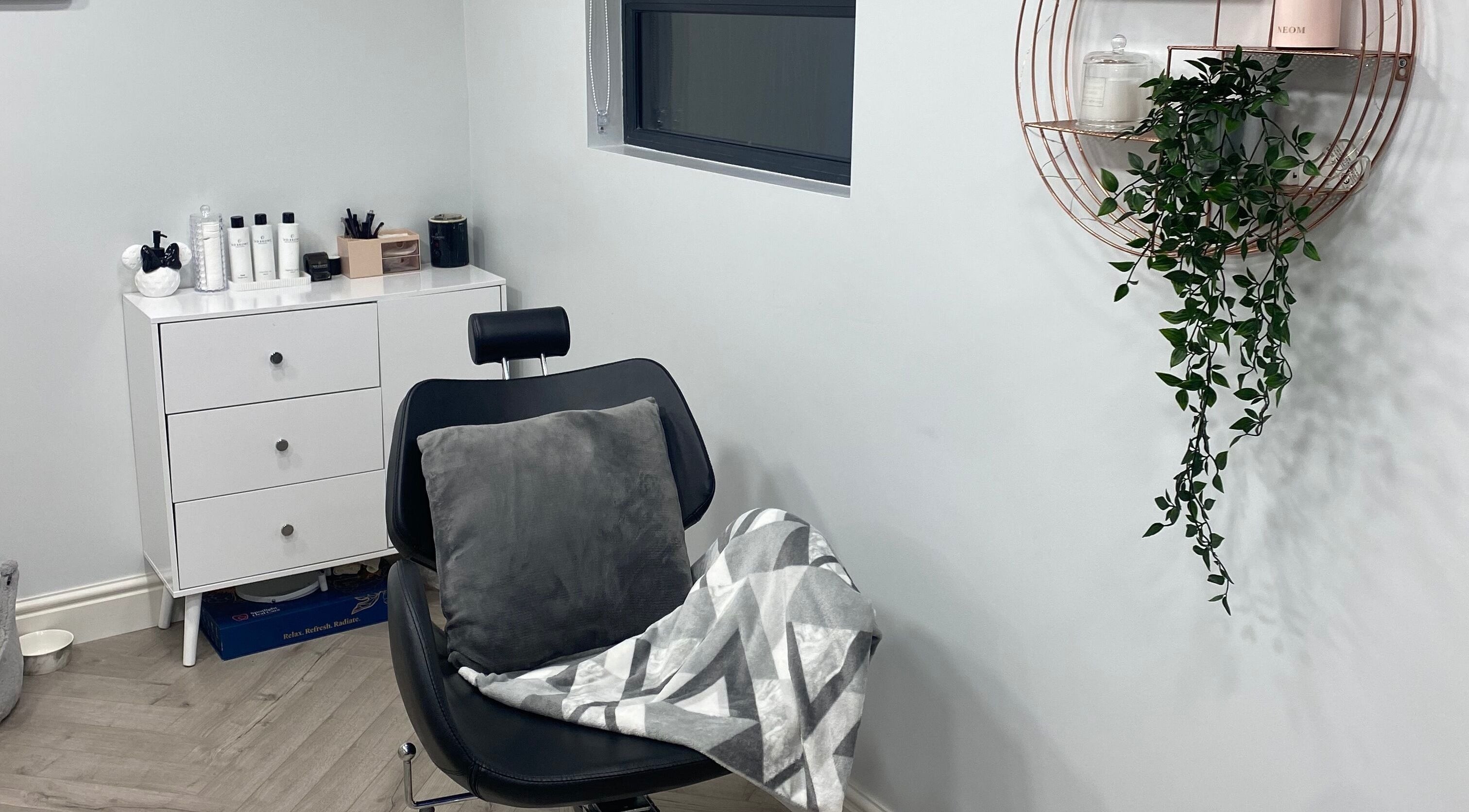 Cozy salon corner in Studio S, Lucan, County Dublin, IE, with a plush chair and soothing decor.