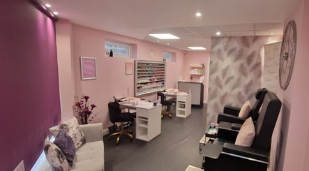 Elegant interior of Brilliance Beauty Salon in Bournemouth featuring nail stations and plush seating.