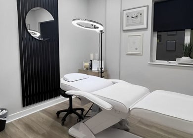 Modern treatment room at Loren Dermody PhiBrows, Carlow, County Carlow, IE with sleek white furniture and decor.