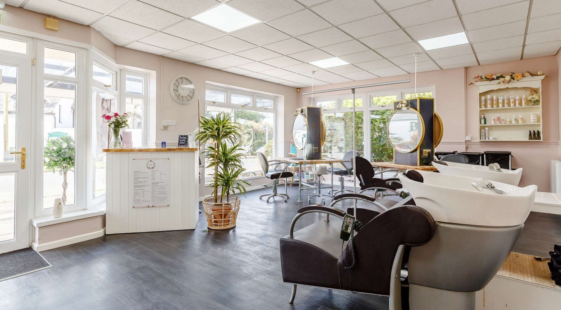 Bright, inviting salon interior at Caribou Hair and Beauty Ltd, Par, England, GB with modern styling stations.