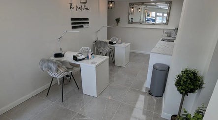 Elegant nail salon setup at Joanne Louise Hair And Beauty, Acle, England, GB, featuring modern decor and cozy seating.