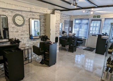 Inside Joanne Louise Hair And Beauty, Acle, England, GB, showcasing sleek styling stations and modern decor.