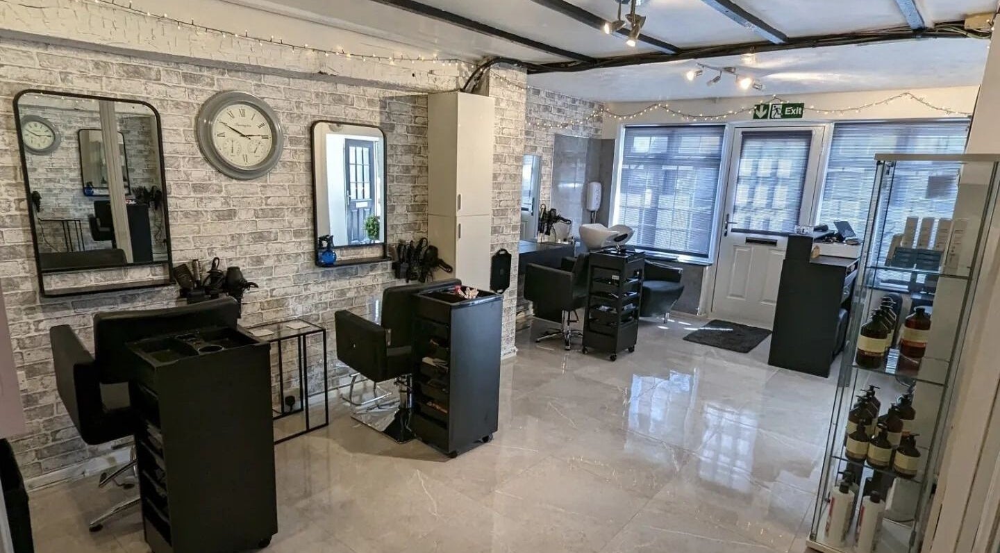 Inside Joanne Louise Hair And Beauty, Acle, England, GB, showcasing sleek styling stations and modern decor.