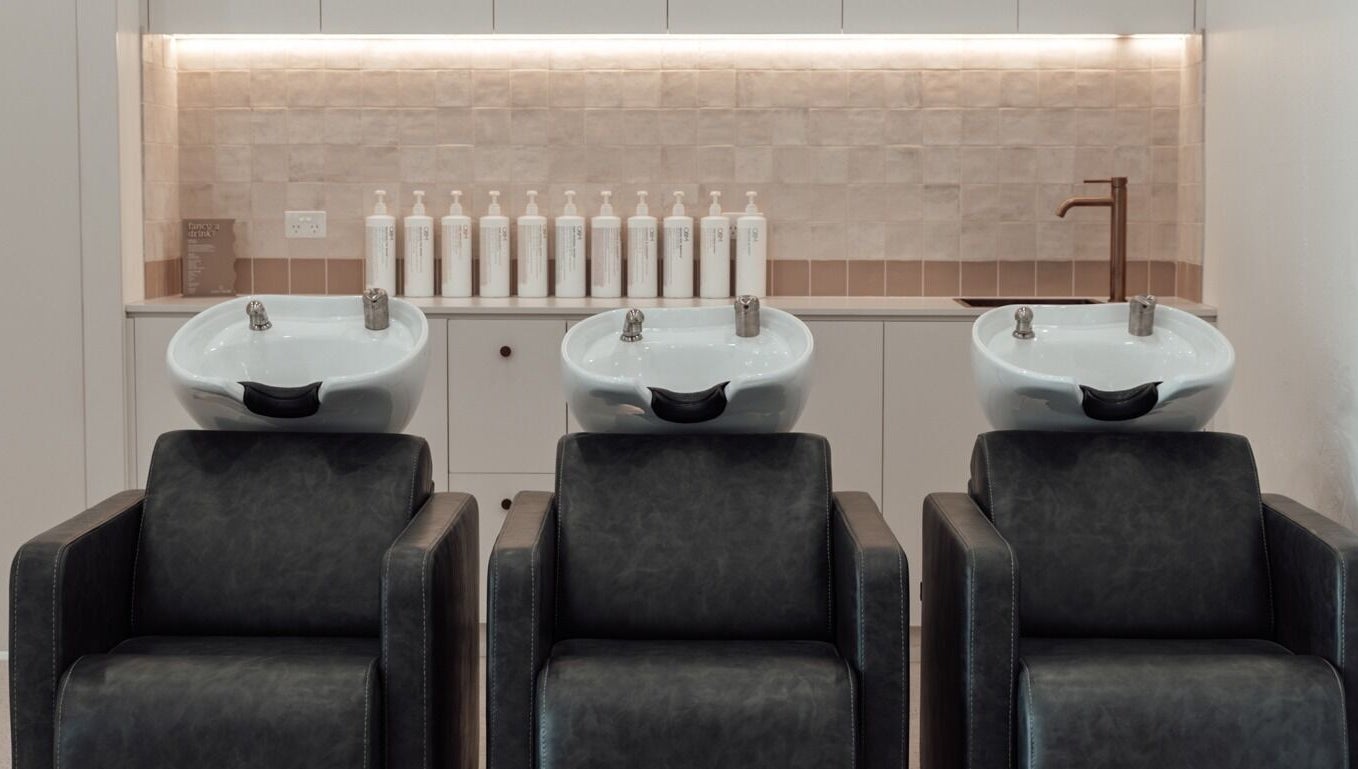 Stylish salon wash stations at Glam Theory Studios, Heathmont, Victoria, AU, offer a relaxing hair care experience.