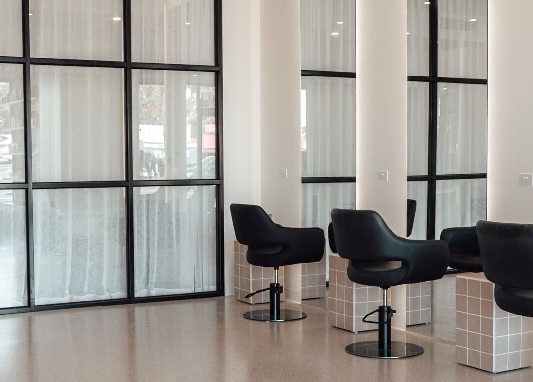 Modern salon interior with chic black chairs at Glam Theory Studios, Heathmont, Victoria, AU.