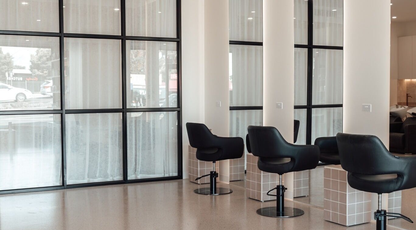 Modern salon interior with chic black chairs at Glam Theory Studios, Heathmont, Victoria, AU.