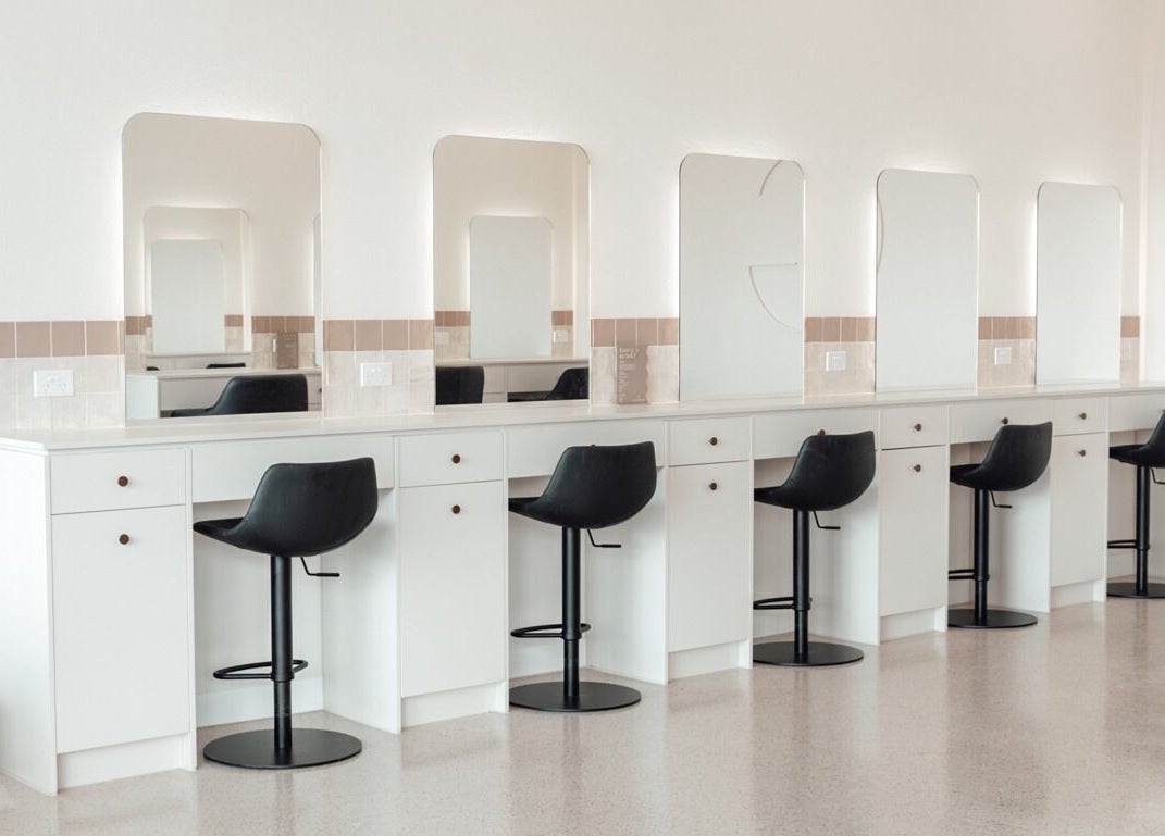 Modern styling stations at Glam Theory Studios in Heathmont, Victoria, AU with sleek mirrors and chairs.