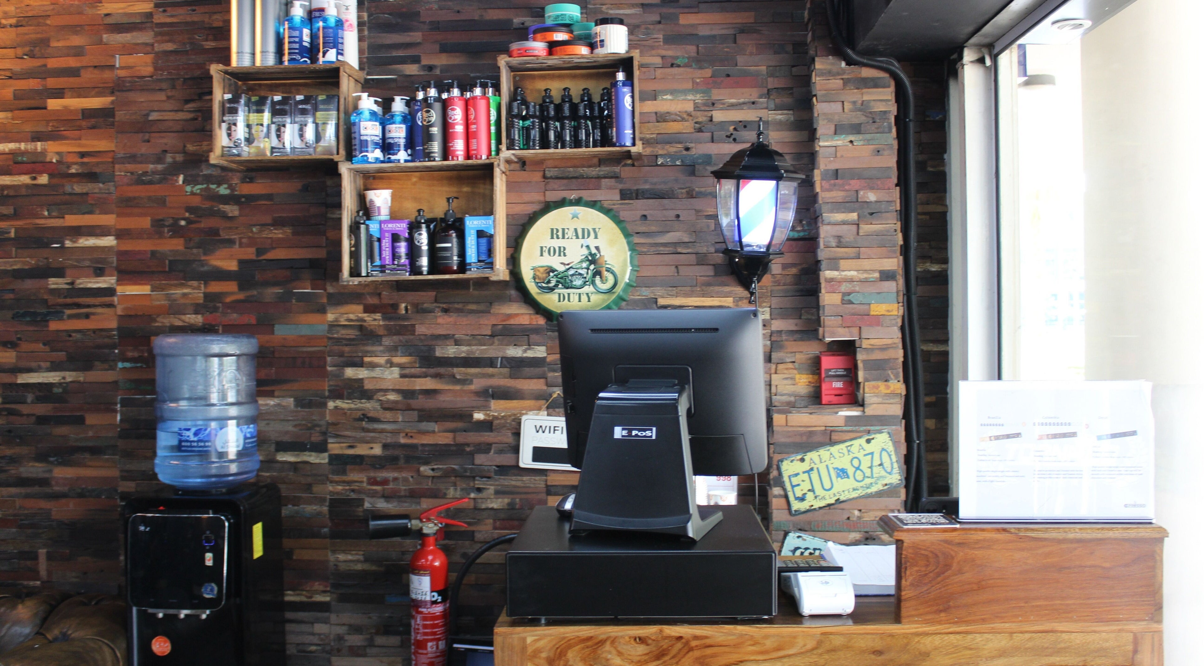 Front desk at Tornado Gents Salon - JLT in Dubai, Dubai, AE with vintage decor and grooming products.