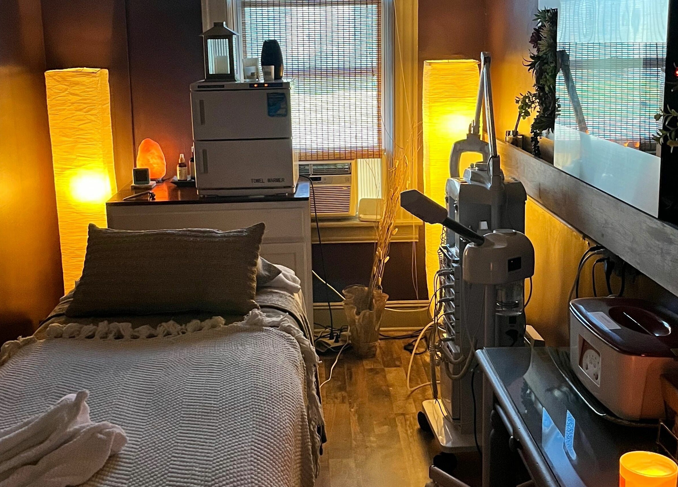 Tranquil massage room at Robert Joseph's Salon, Syracuse, New York, US. Warm lighting and cozy ambiance.