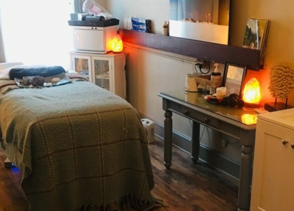 Relaxing treatment room at Robert Joseph's Salon in Syracuse, New York, US. Cozy setting with massage table.