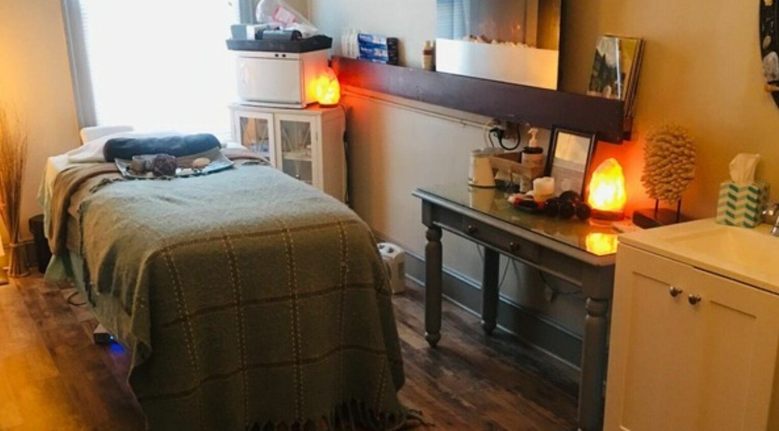 Relaxing treatment room at Robert Joseph's Salon in Syracuse, New York, US. Cozy setting with massage table.
