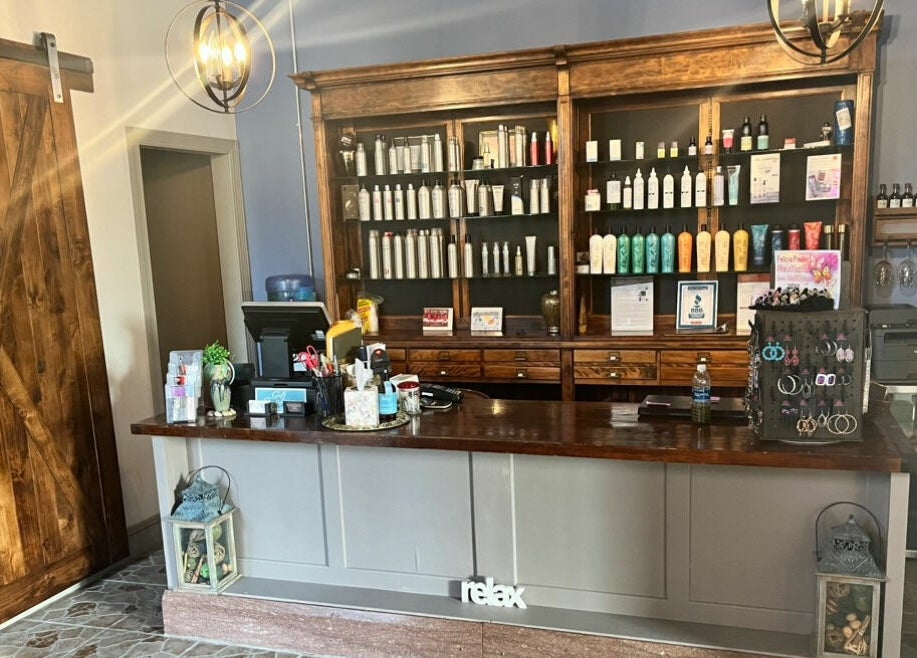 Reception area in Robert Joseph's Salon, Syracuse, New York, US featuring wooden decor and beauty products display.