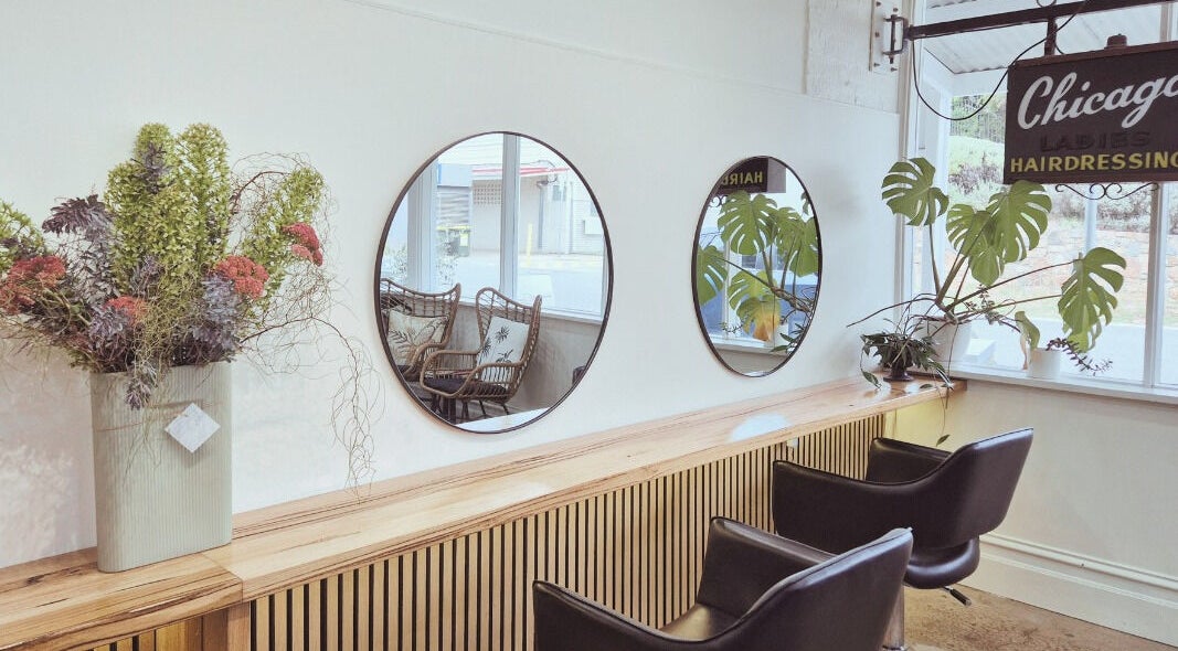 Elegant styling area at Chicago Hair at Sorrento in Sorrento, Victoria, AU, featuring plush chairs and modern decor.