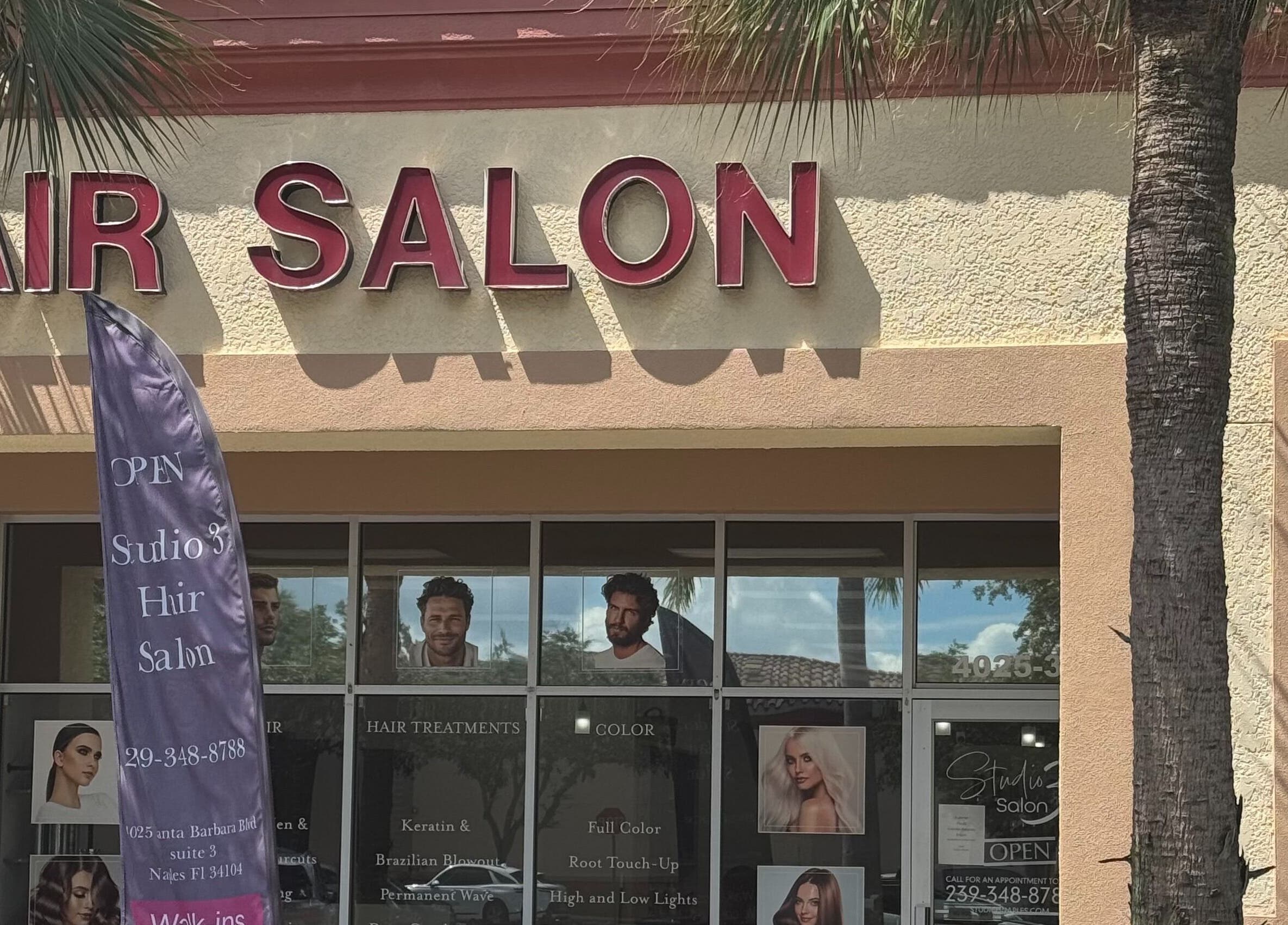 Exterior of Studio 3 hair salon in Naples, Florida, US, showcasing vibrant signage and entrance.