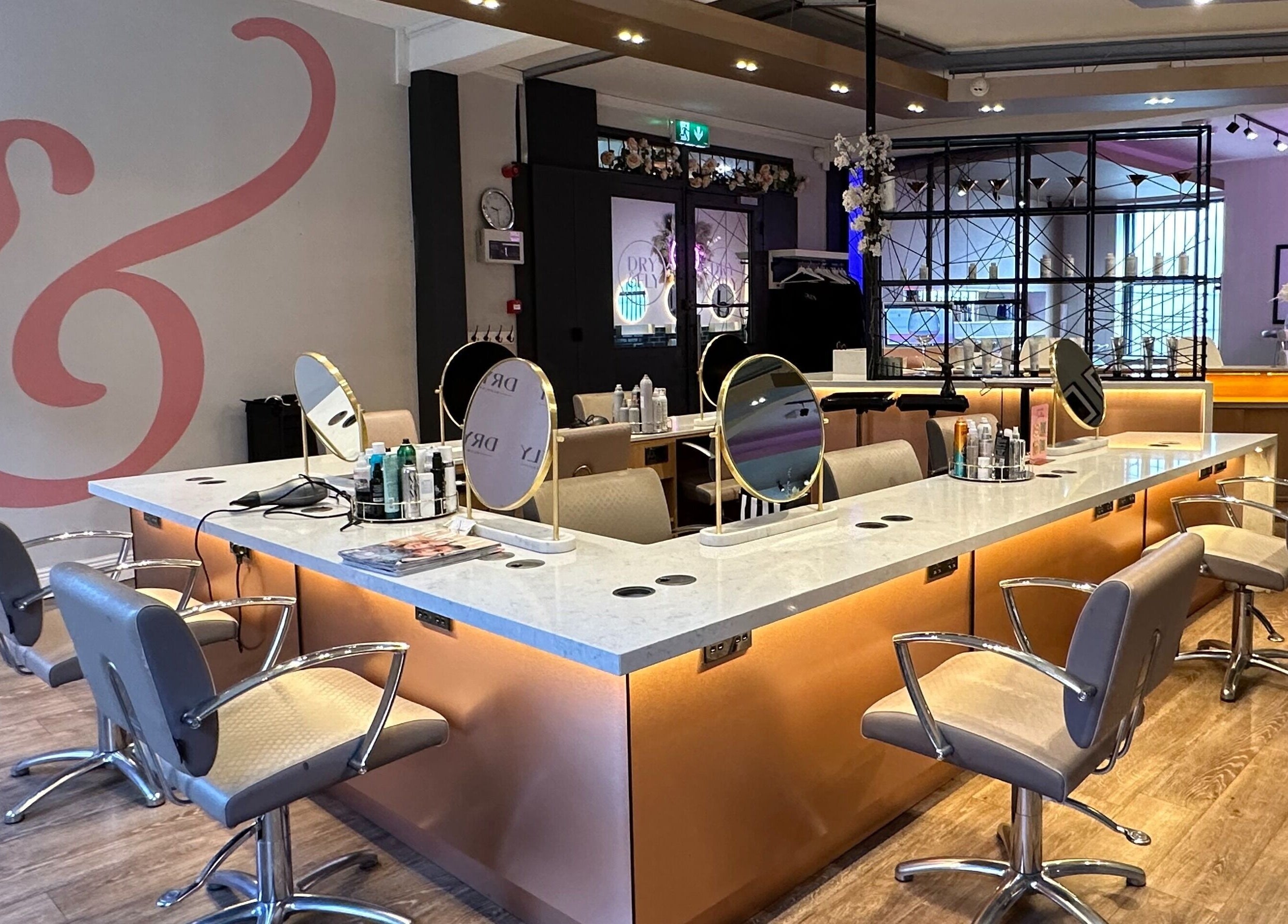 Modern salon setting at Dry & Fly Wicklow Street, Dublin, County Dublin, IE with elegant styling chairs and mirrors.