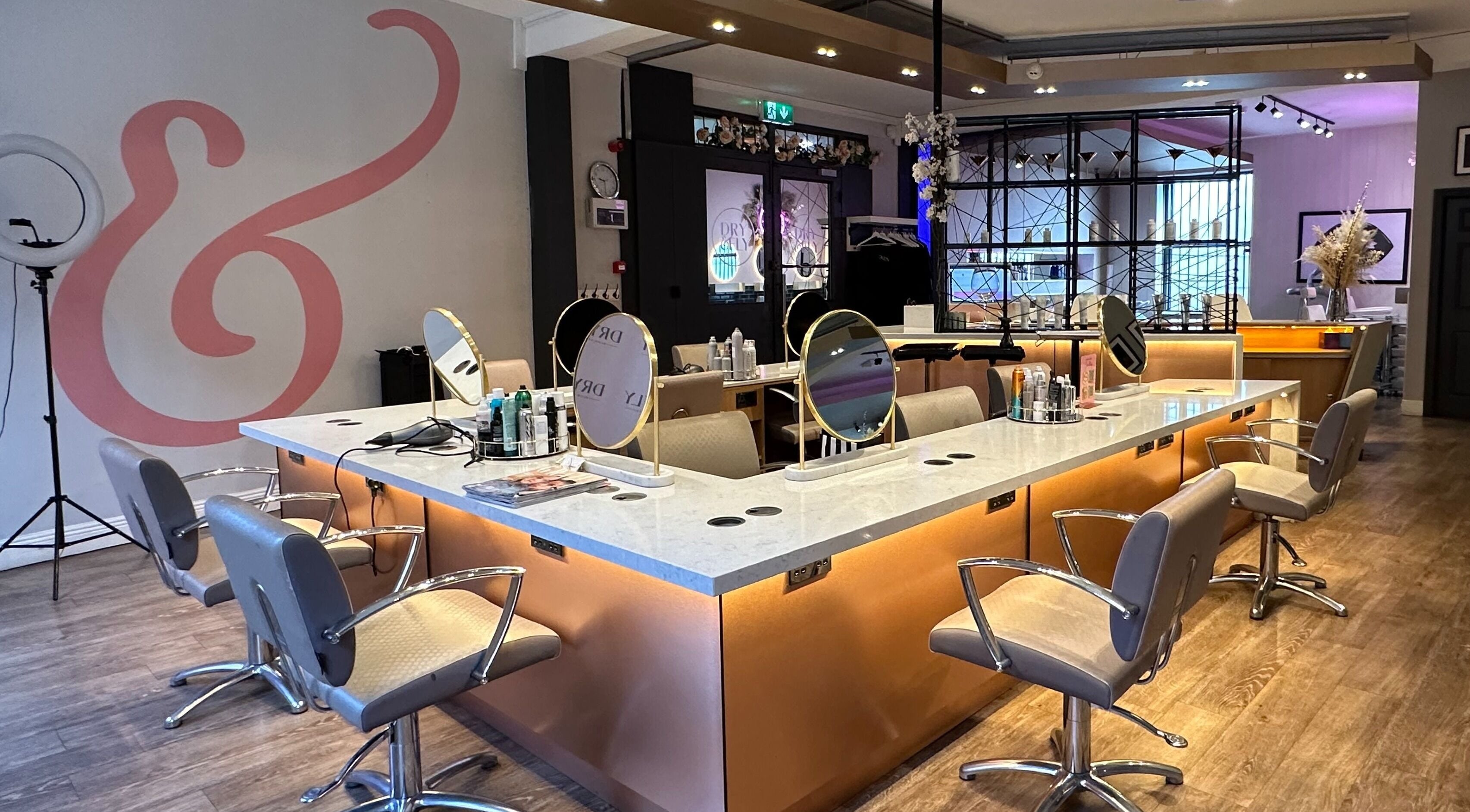 Modern salon setting at Dry & Fly Wicklow Street, Dublin, County Dublin, IE with elegant styling chairs and mirrors.