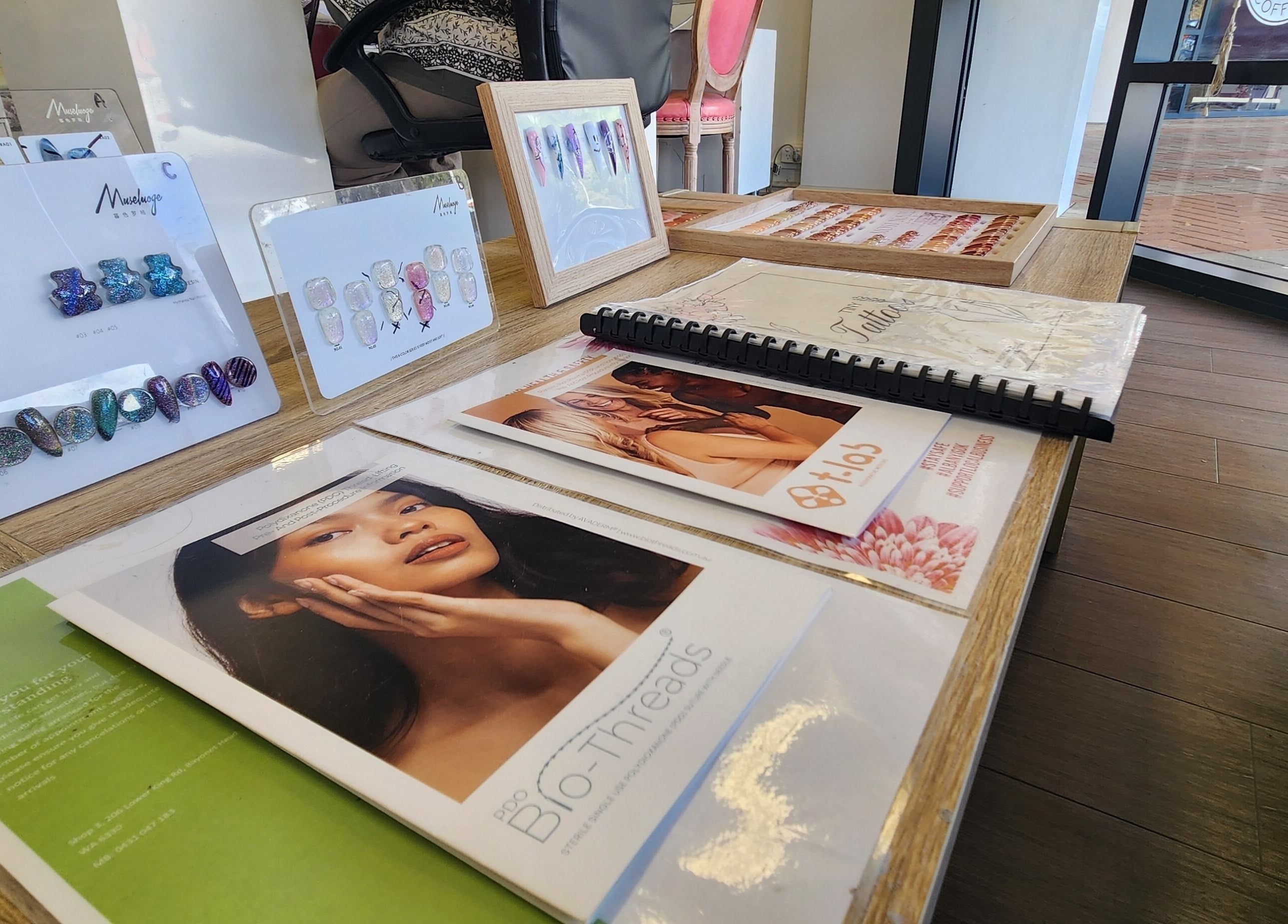 Display of beauty services at Chee Chee Salon, Bayonet Head, Western Australia, AU, featuring nail art and brochures.