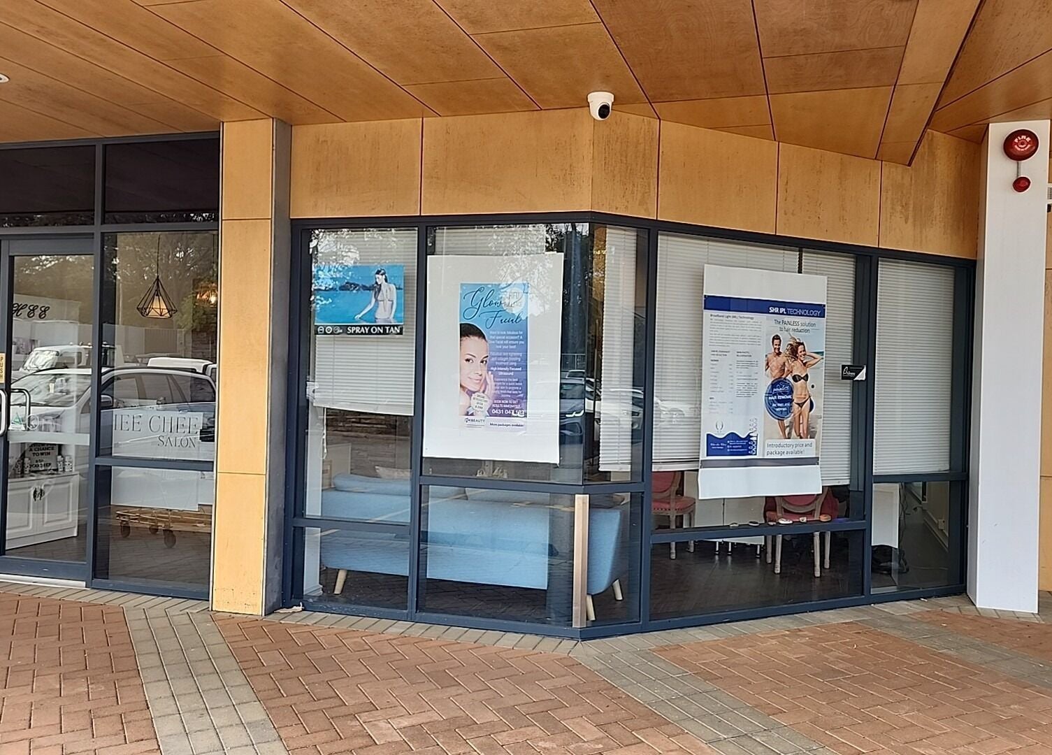 Exterior view of Chee Chee Salon in Bayonet Head, Western Australia, AU with promotional posters on windows.