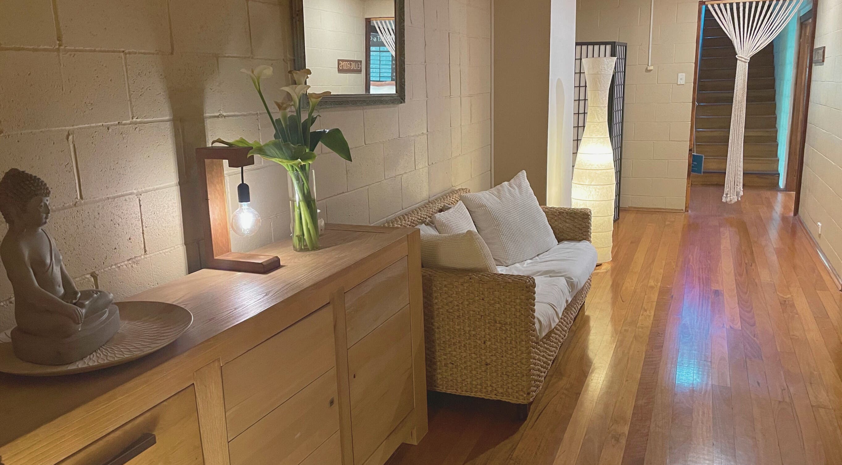 Cozy seating area at Heart and Soul Wellness Centre, Otford, New South Wales, AU with warm lighting and decor.