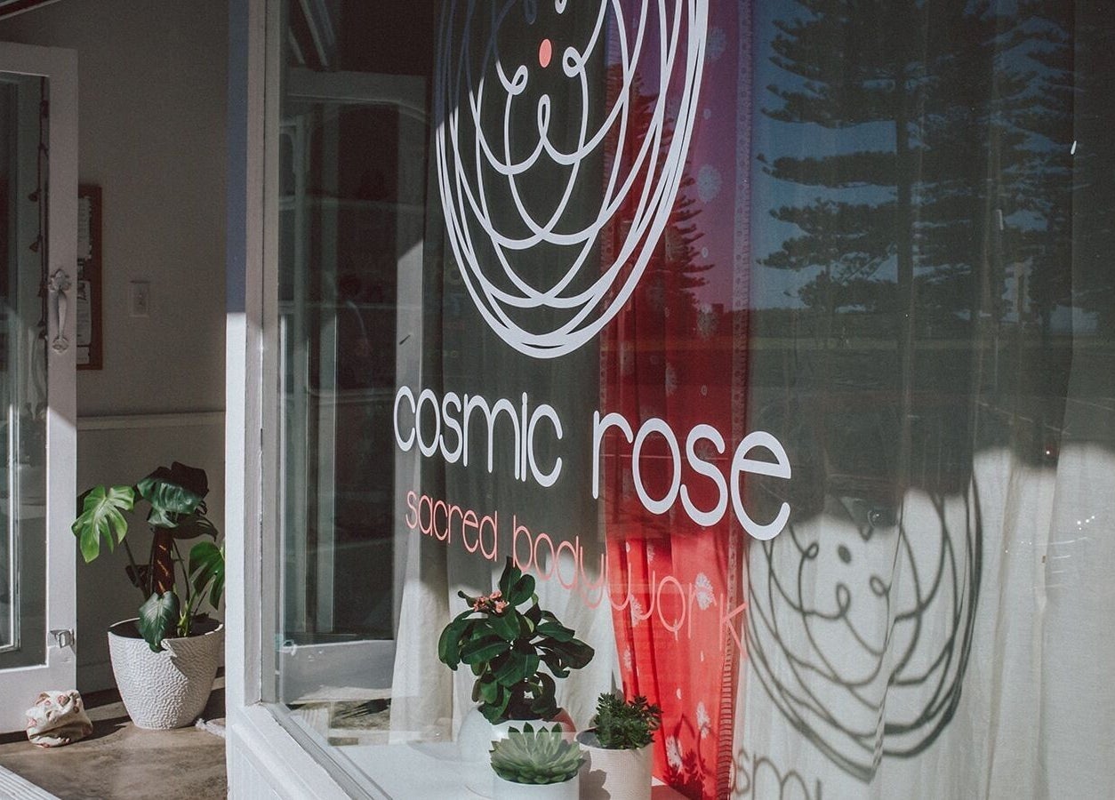 Entrance to Cosmic Rose in Newport, New South Wales, AU with plants and logo in view.