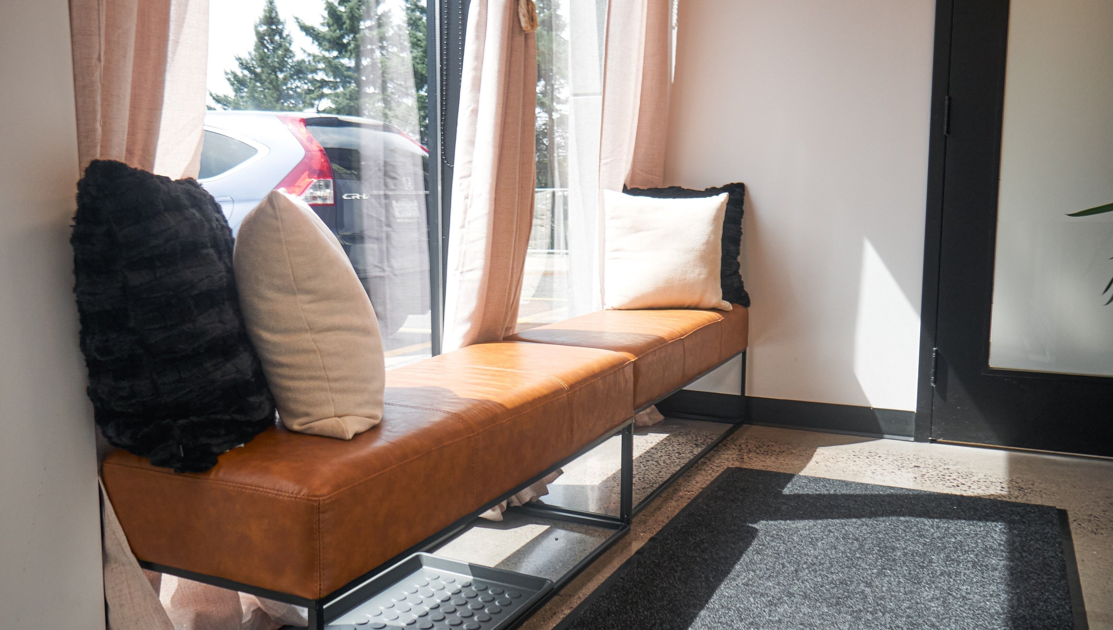 Relaxing seating at Nova Wax Bar Ltd., Ottawa, Ontario, CA with plush cushions and natural light.