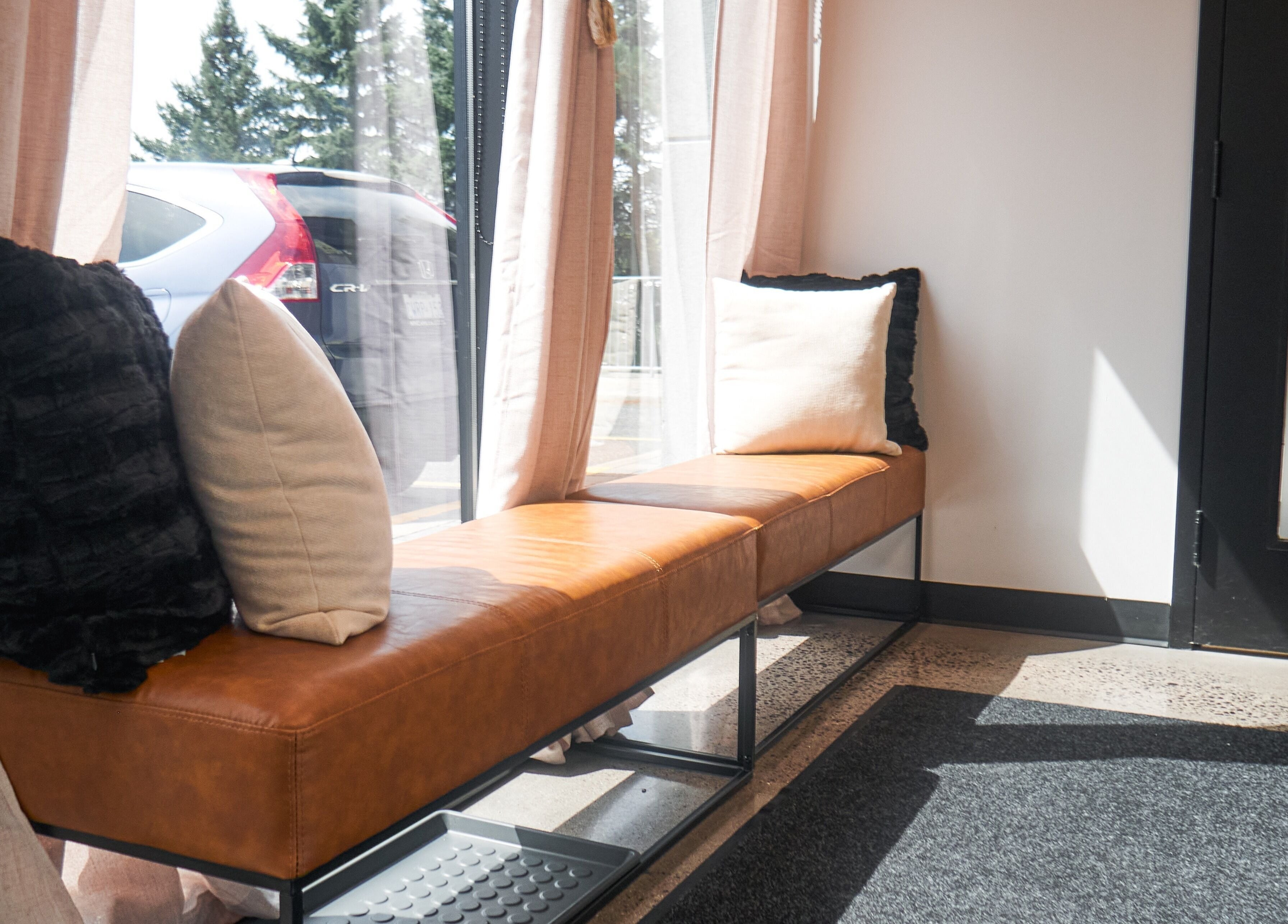 Relaxing seating at Nova Wax Bar Ltd., Ottawa, Ontario, CA with plush cushions and natural light.