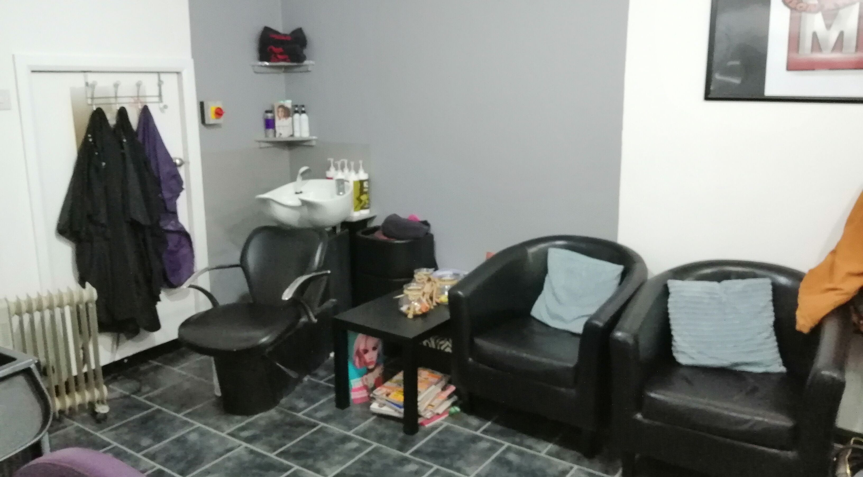 Seating area at Mel at Salon Arriba, Stoke-on-Trent, England, GB showcasing modern chairs and salon essentials.