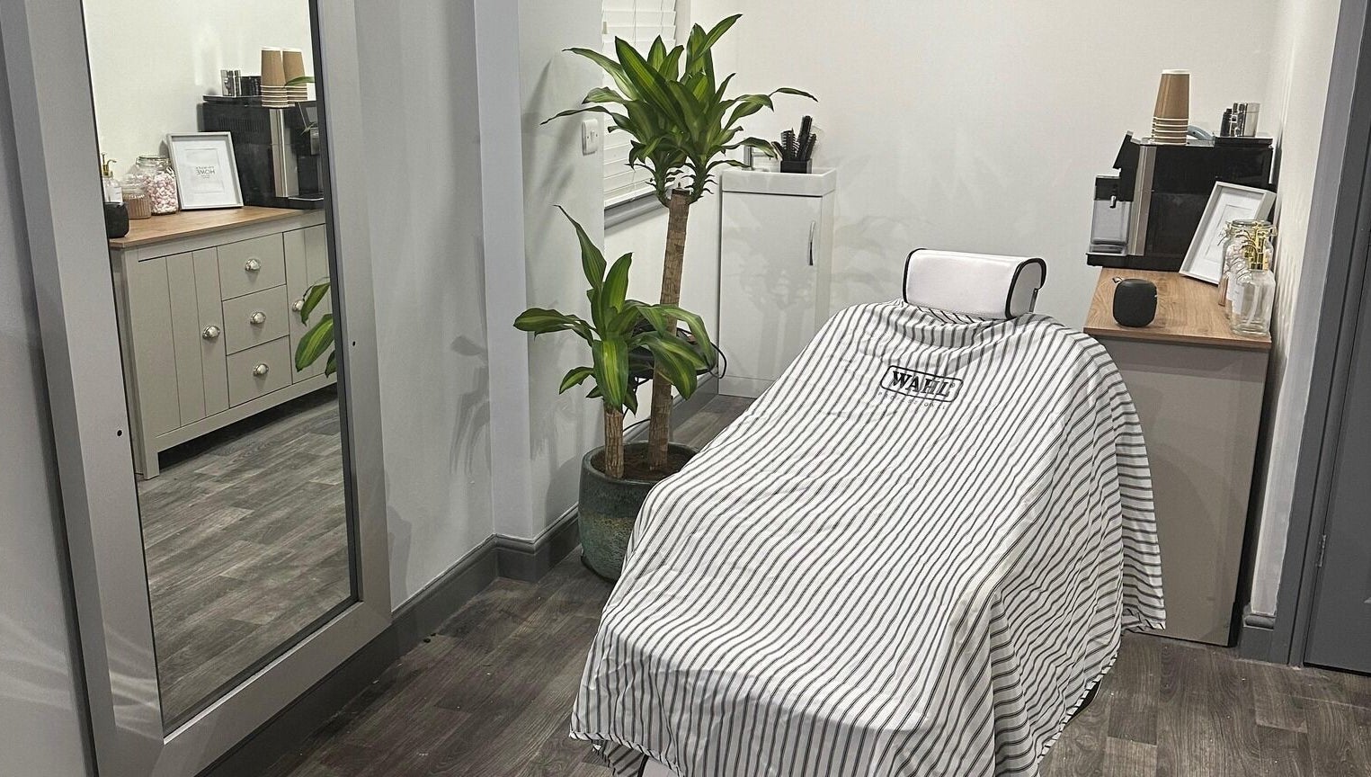 Modern salon chair in The Skinned Lid, Huddersfield, England, GB, inviting relaxation and style.