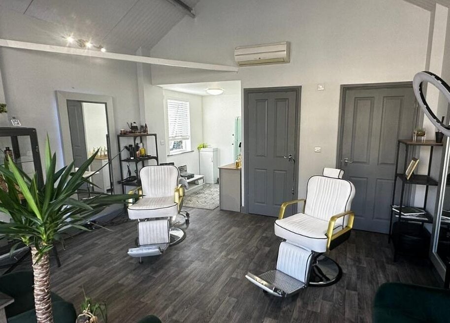 Elegant barber chairs in The Skinned Lid, Huddersfield, England, GB offer a stylish grooming experience.