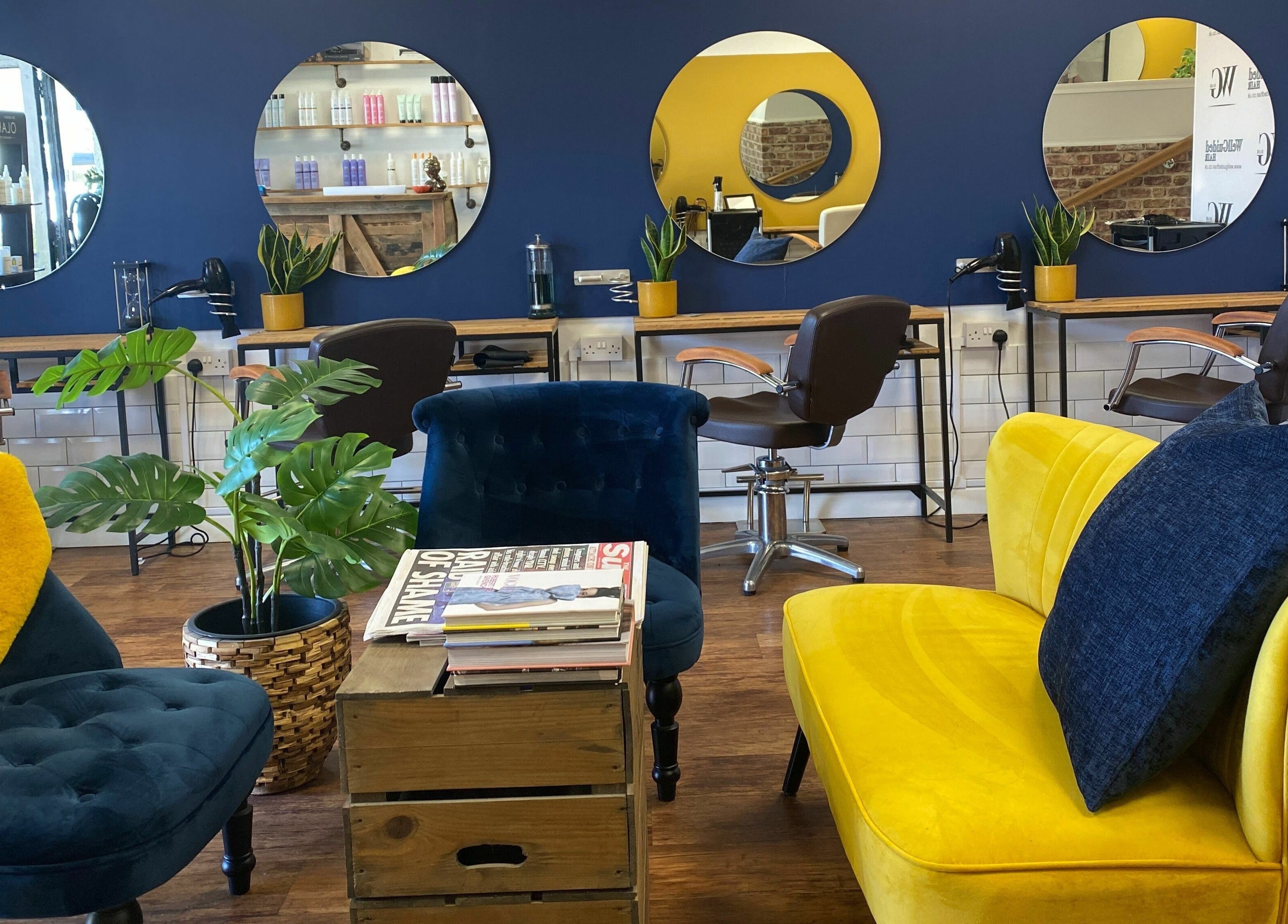 Chic seating and mirrors at Well Guided Hair, Torquay, England, GB.