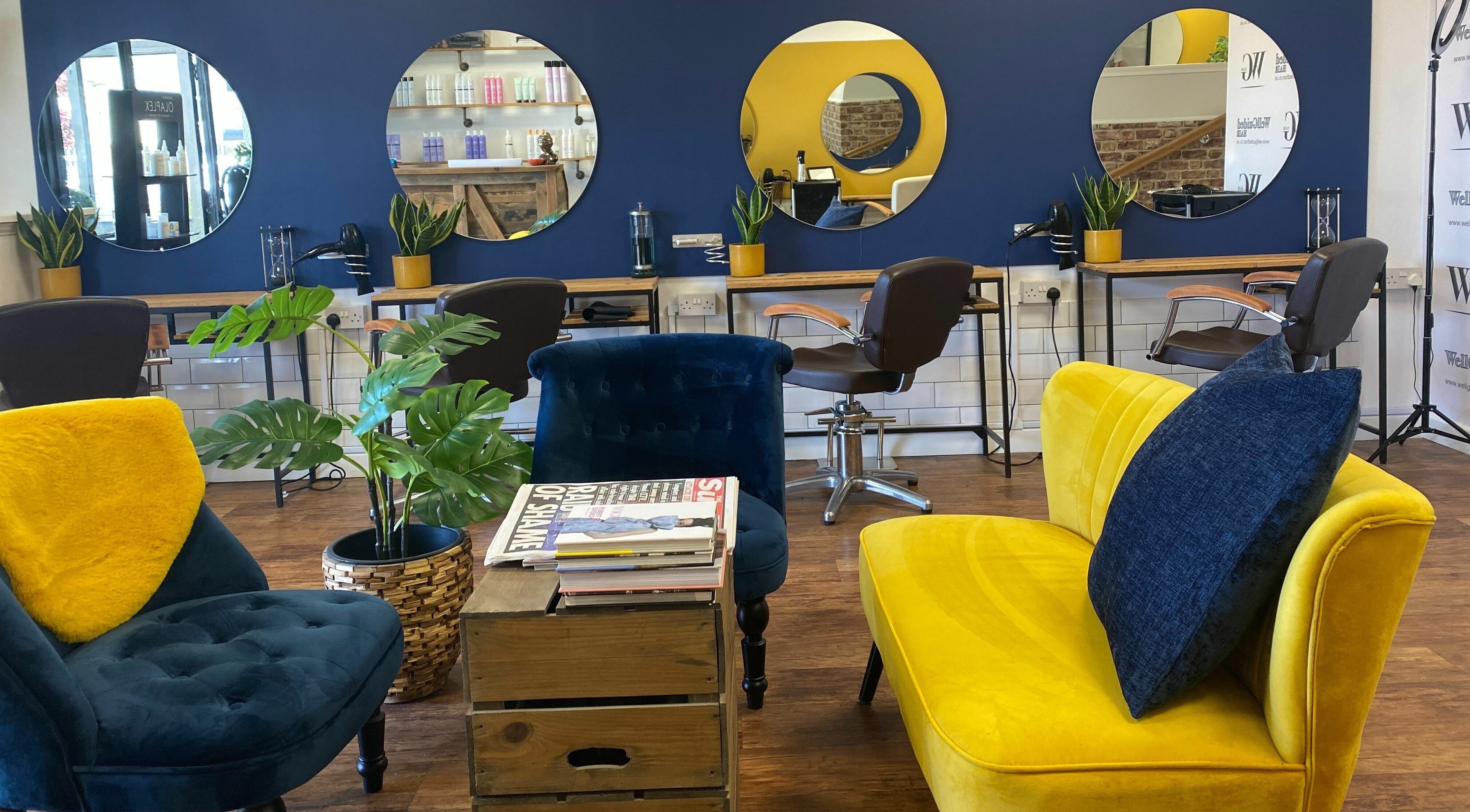 Chic seating and mirrors at Well Guided Hair, Torquay, England, GB.
