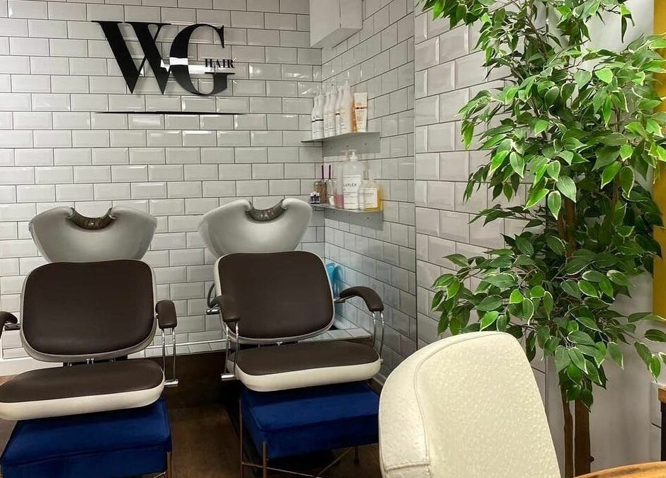 Stylish hair washing station at Well Guided Hair, Torquay, England, GB with modern decor and lush greenery.