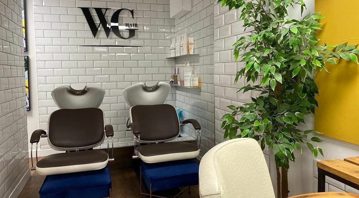Stylish hair washing station at Well Guided Hair, Torquay, England, GB with modern decor and lush greenery.