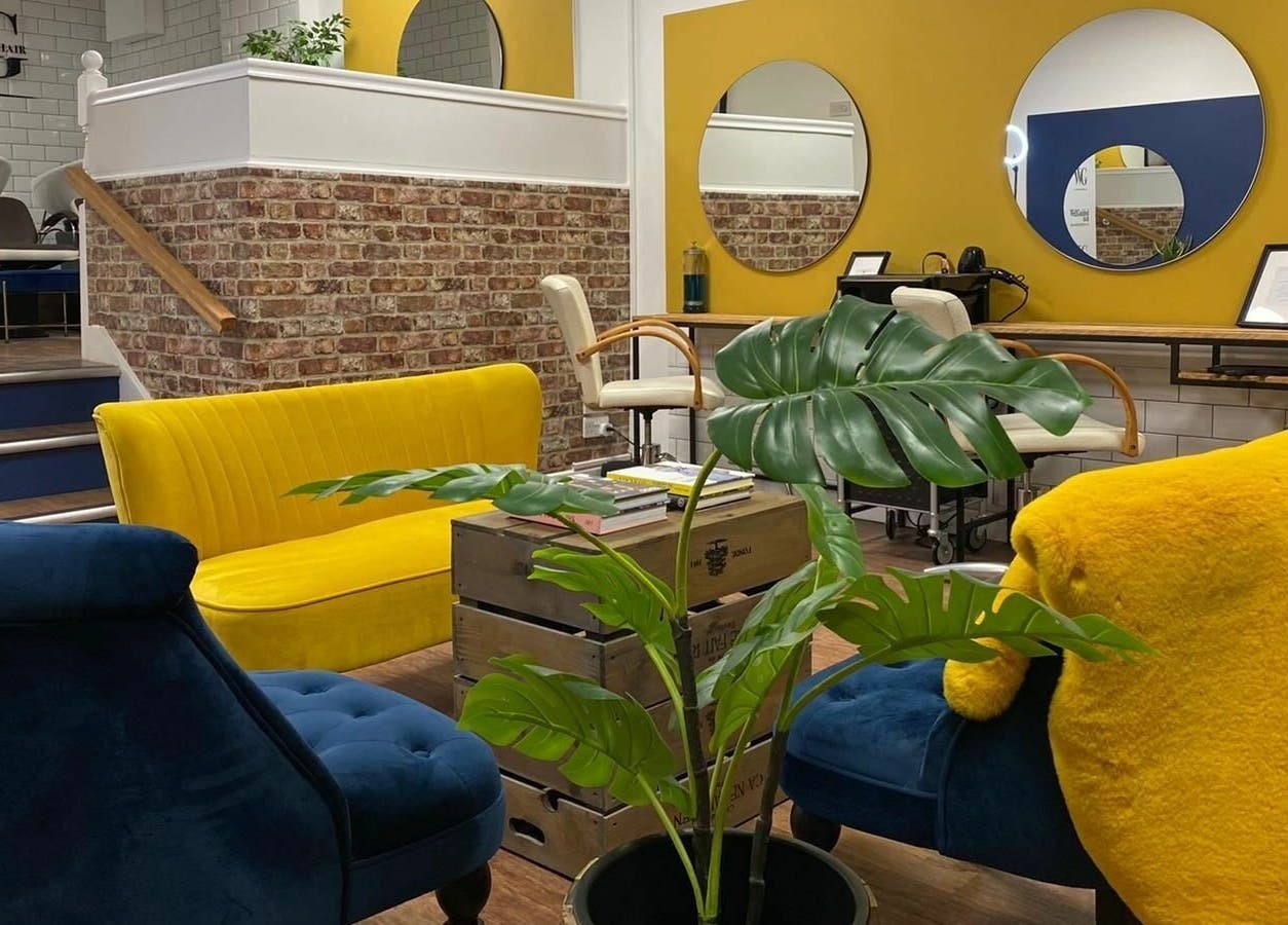 Stylish salon seating area with vibrant colors at Well Guided Hair, Torquay, England, GB.
