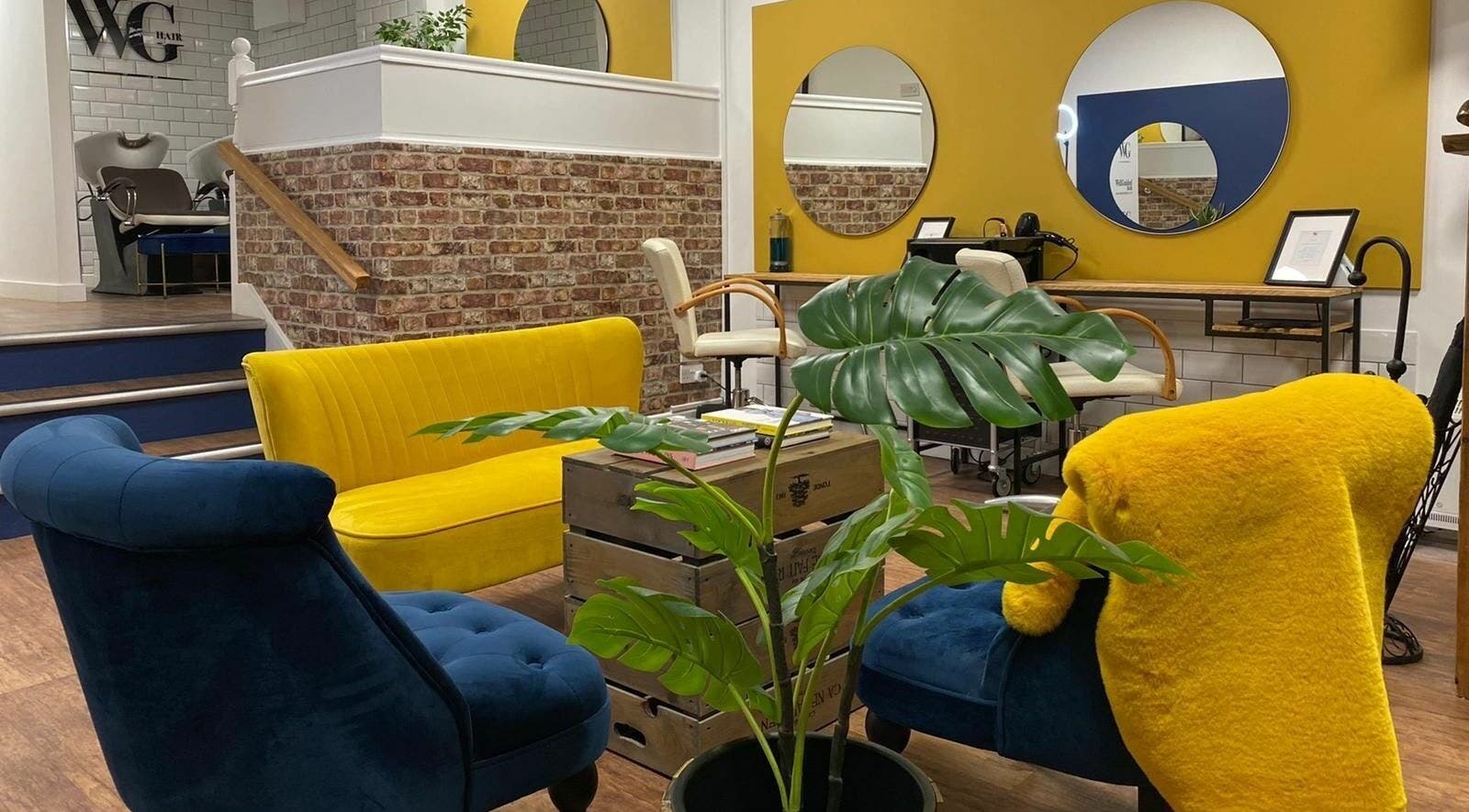 Stylish salon seating area with vibrant colors at Well Guided Hair, Torquay, England, GB.