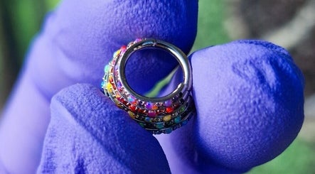 Colorful hoop earring showcased at Envy Tattoo Studio, Kirkcaldy, Scotland, GB.