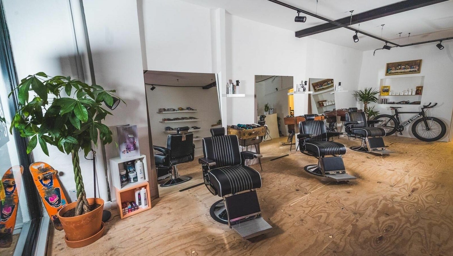 Modern barber chairs and decor at Cuts and Creps, Bristol, England, GB, showcasing a stylish interior.