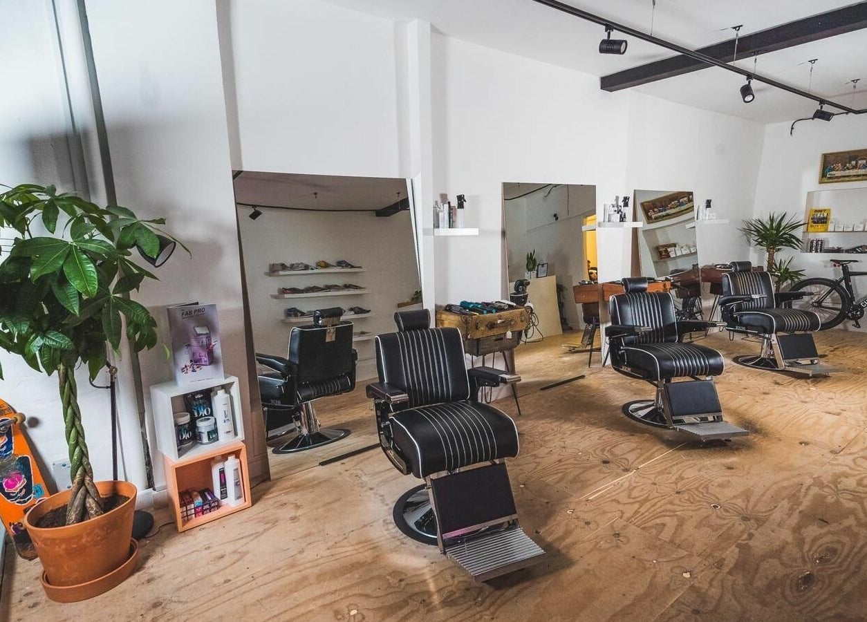Modern barber chairs and decor at Cuts and Creps, Bristol, England, GB, showcasing a stylish interior.