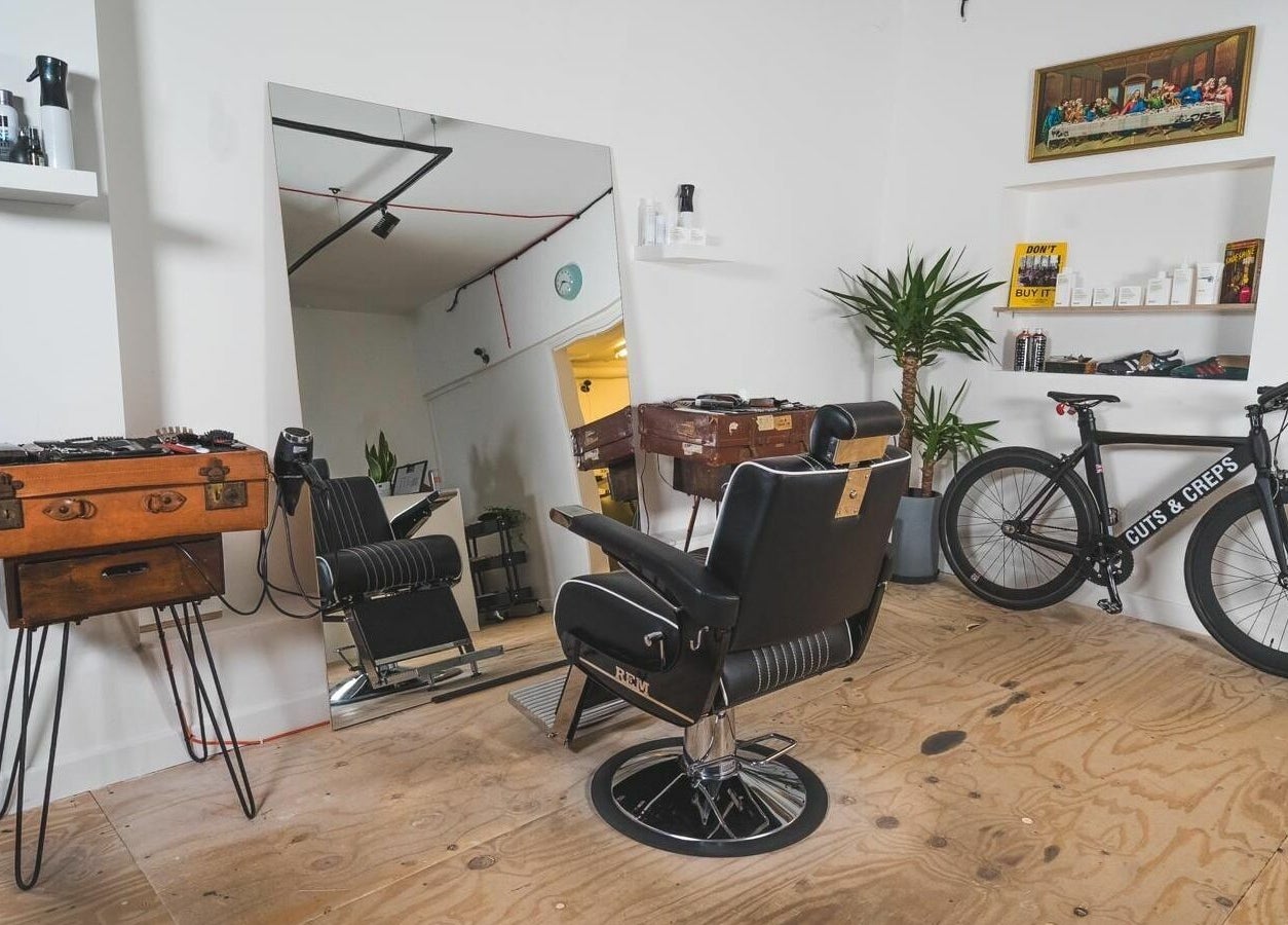 Modern barber chair and bicycle in Cuts and Creps, located in Bristol, England, GB.
