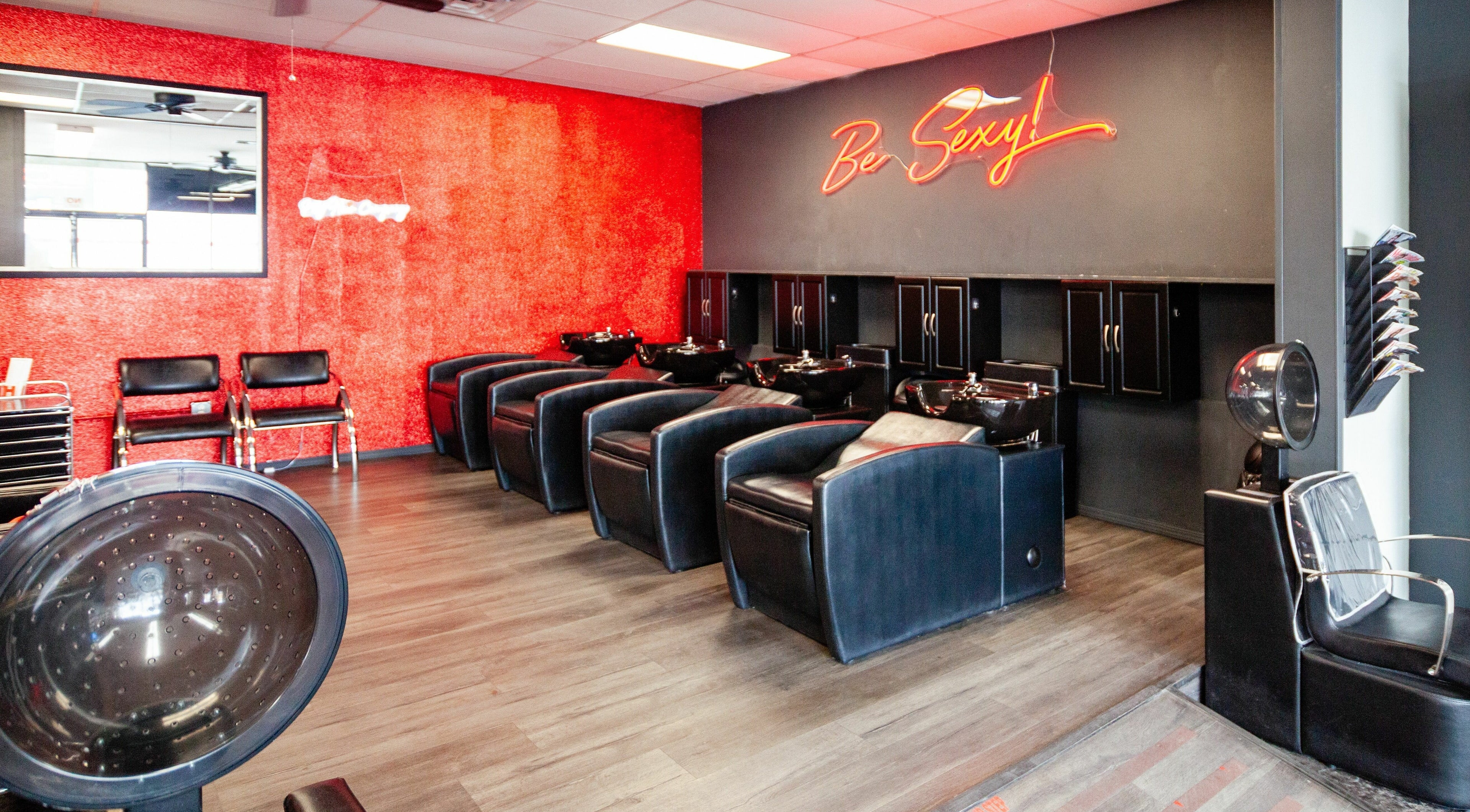 Chic salon interior at NY Hair 1550 - E. Tropicana, Las Vegas, Nevada, US with black chairs and red walls.