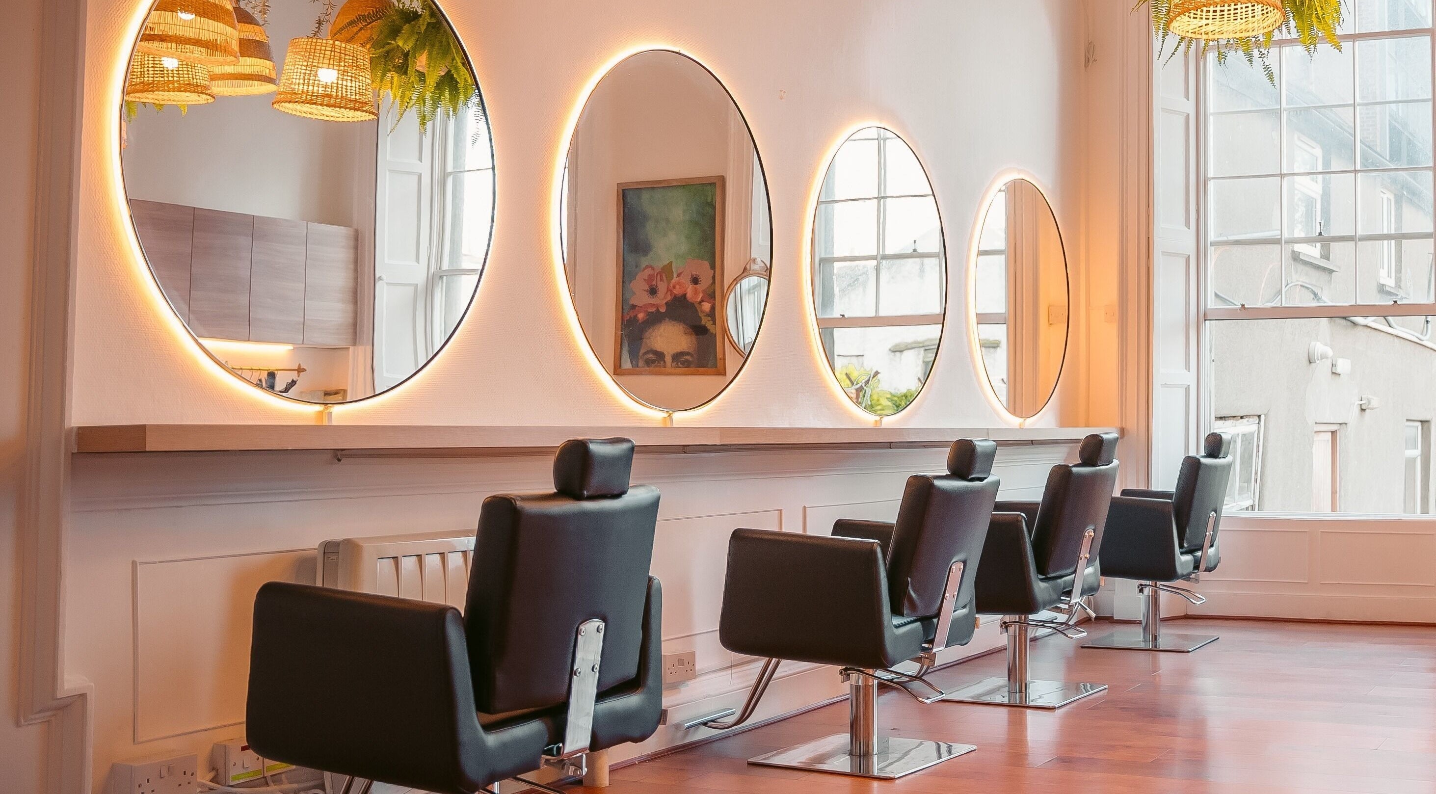 Interior of Gabriela Leite Curly Hair Salon, Dublin, with stylish mirrors and modern chairs, County Dublin, IE.