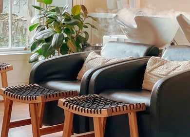 Comfortable seating at Gabriela Leite Curly Hair Salon, Dublin, County Dublin, IE with lush green plants.