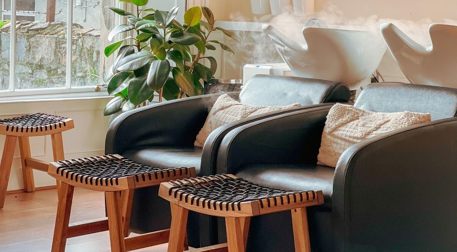 Comfortable seating at Gabriela Leite Curly Hair Salon, Dublin, County Dublin, IE with lush green plants.