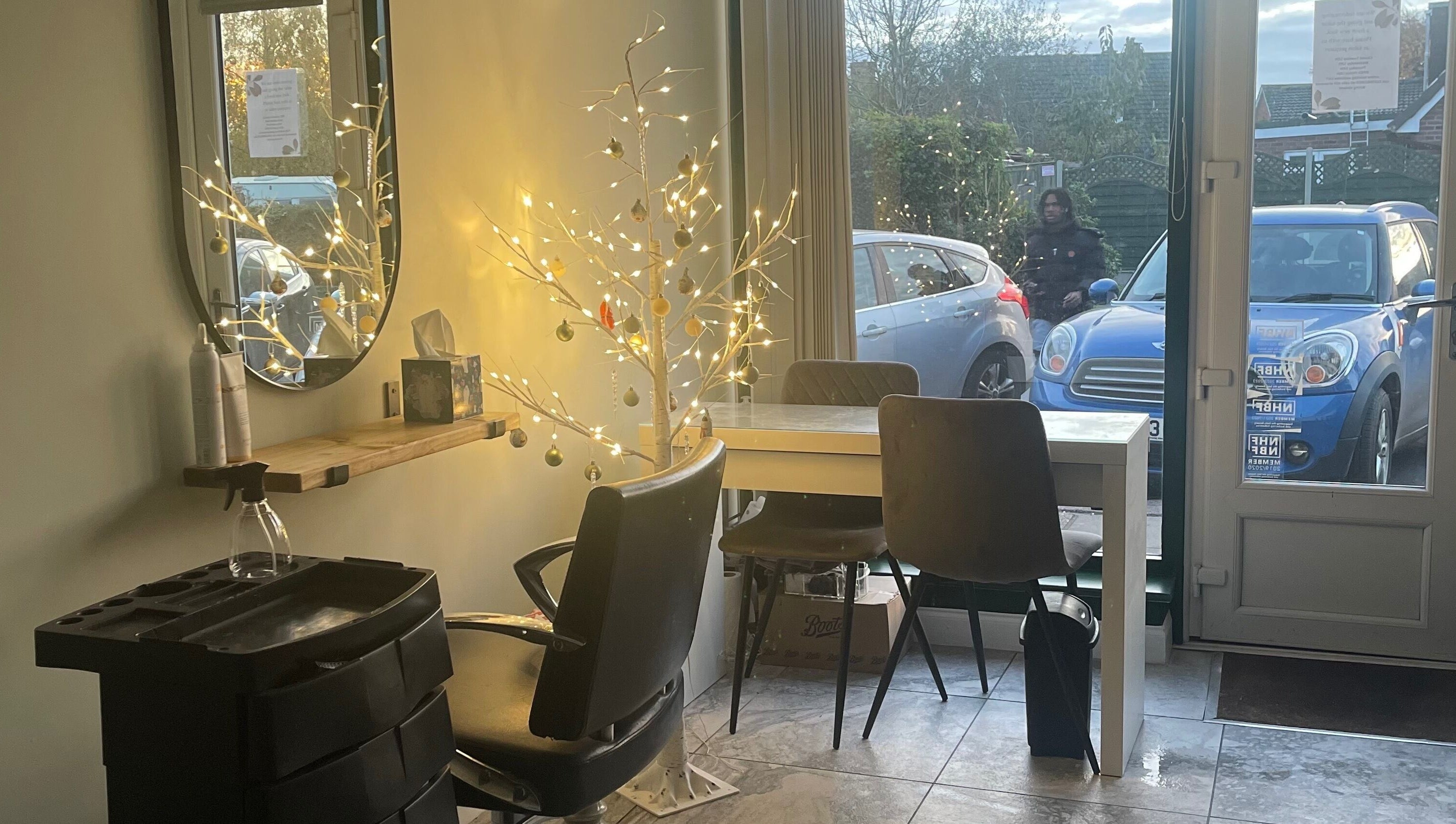 Serene salon interior with festive lights at Salon Seven, Wivenhoe, England, GB.